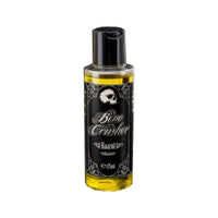 Bone Crusher Aceite capilar - vista frontal de botella de 125 ml con etiqueta de calavera y aceite amarillo