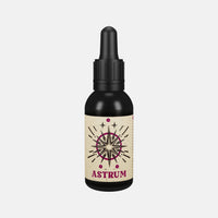 By Elementum Mollis Astrum Beard Oil, vista frontal del frasco negro con pipeta y etiqueta de estrellas