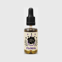 By Elementum Mollis Floral Beard Oil, vista frontal del frasco con etiqueta de flor y tapón de pipeta